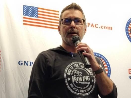 Ian Murphy speaking at a podium